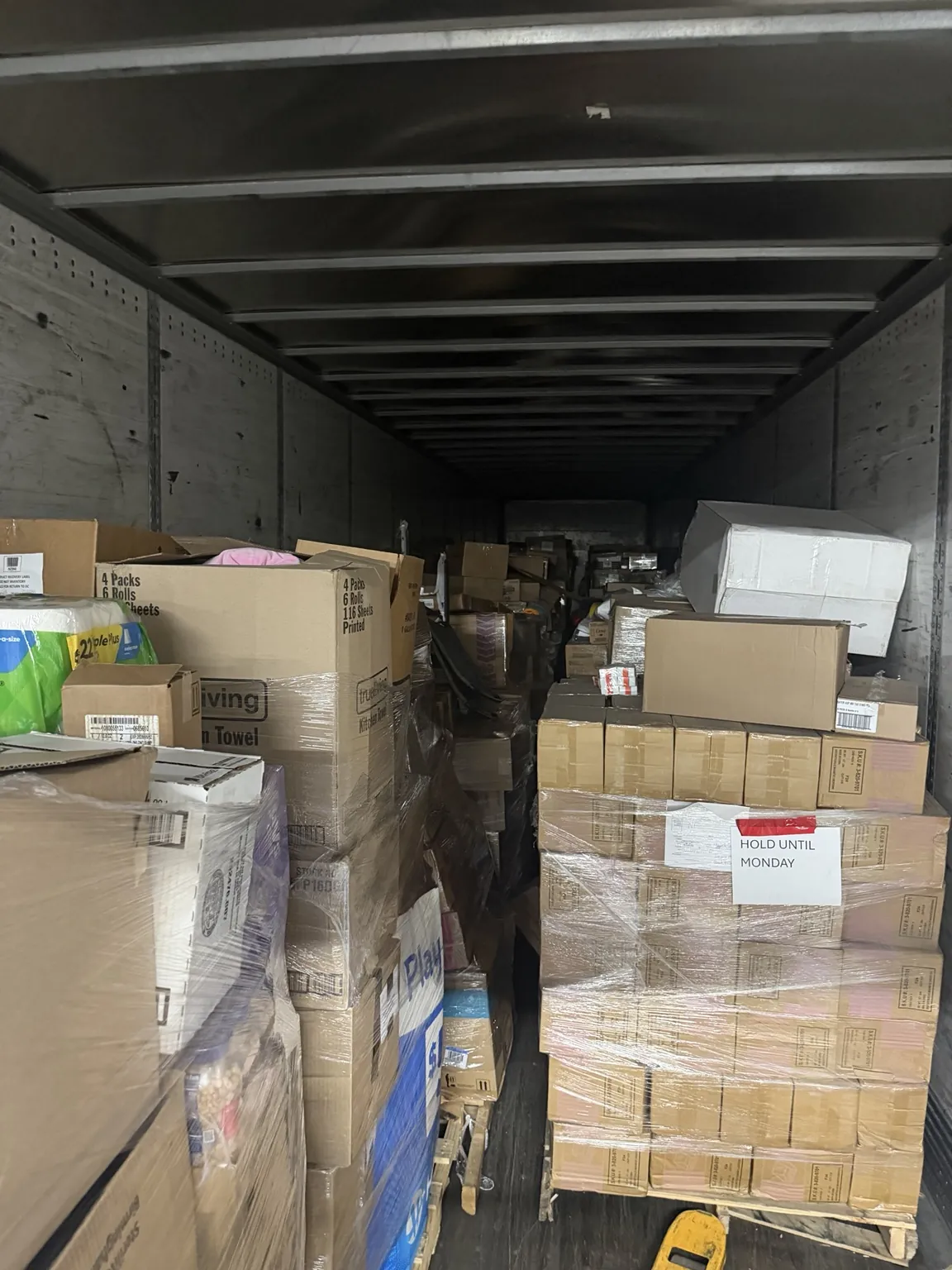 Truck loaded with pallets and boxes arriving for restock
